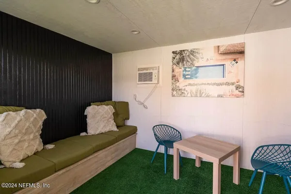 a view of backyard with seating space and trees