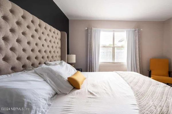 a bedroom with a bed and a window