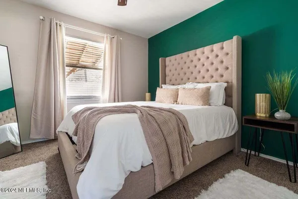 a bedroom with a bed and a window