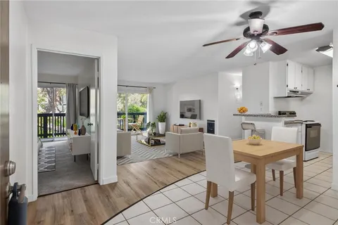 a view of a dining room with furniture a chandelier and wooden floor