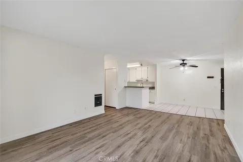 a view of a kitchen with wooden floor and a sink