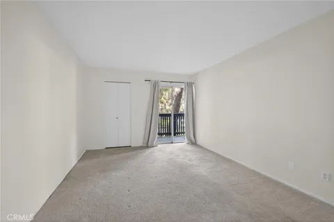 an empty room with closet area