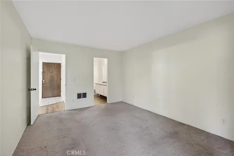a bathroom with a granite countertop sink a toilet a mirror and shower