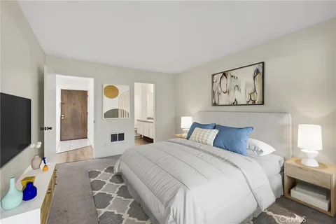 a bedroom with a bed and a flat screen tv