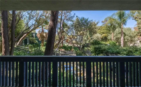 a balcony with lots of green space and plants