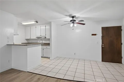 a view of a kitchen with a sink dishwasher a refrigerator and cabinets