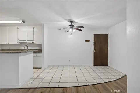 a view of an empty room and kitchen view