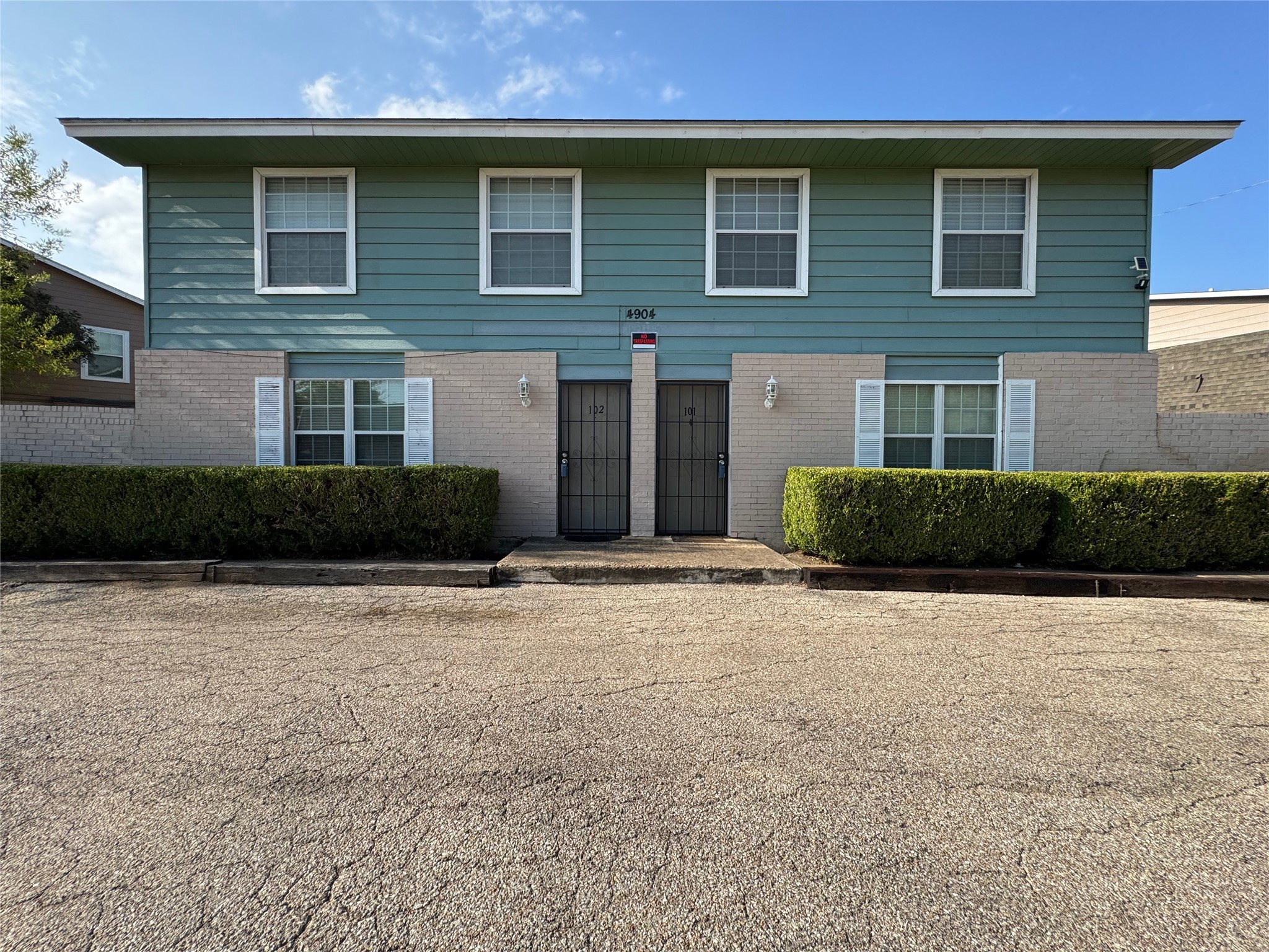4904 West Wind Trail, Unit 102 Austin, TX 78745 - Photo 1 of 23 a front view of a house with garage and plants