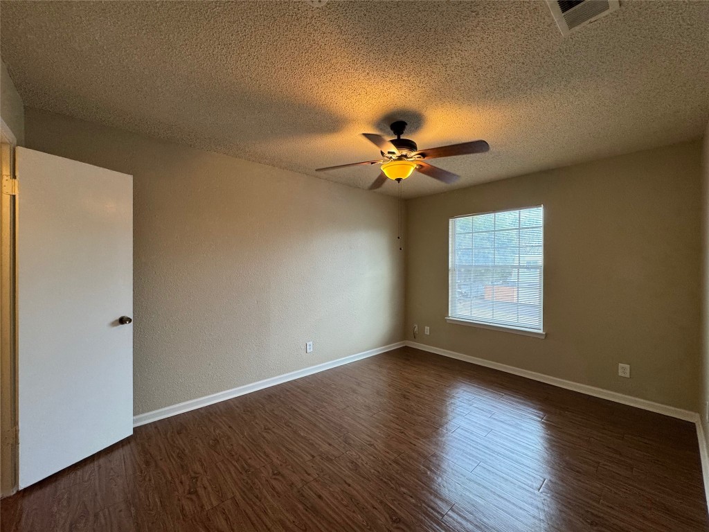 4904 West Wind Trail, Unit 102 Austin, TX 78745 - Photo 16 of 23 a view of an empty room with a window and wooden floor