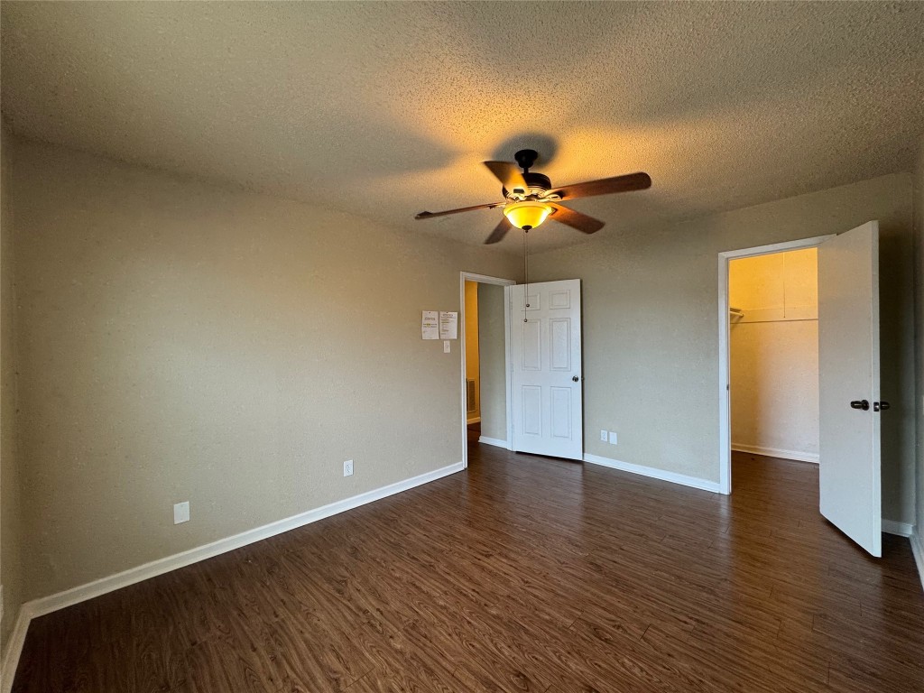 4904 West Wind Trail, Unit 102 Austin, TX 78745 - Photo 17 of 23 a view of an empty room with a window and wooden floor