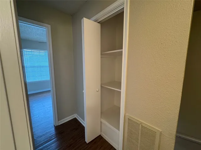 a view of hallway with wooden floor