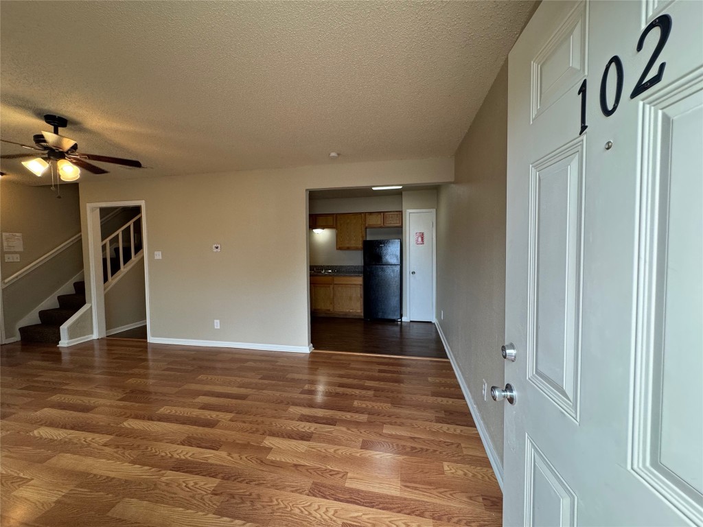 4904 West Wind Trail, Unit 102 Austin, TX 78745 - Photo 2 of 23 a view of a hallway with wooden floor
