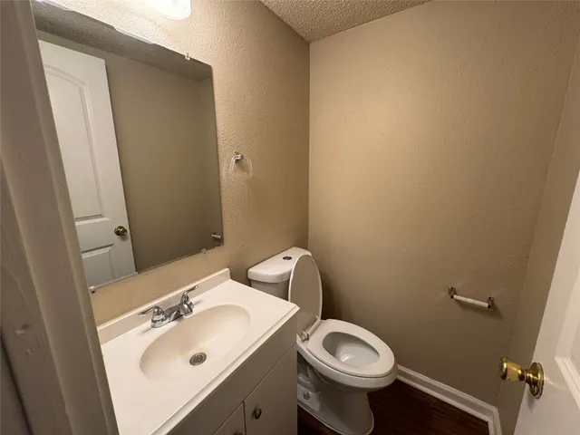a bathroom with a sink mirror and toilet