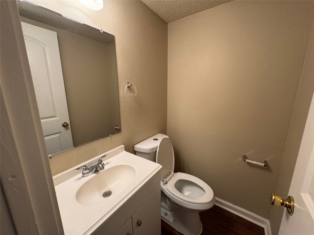4904 West Wind Trail, Unit 102 Austin, TX 78745 - Photo 9 of 23 a bathroom with a sink mirror and toilet