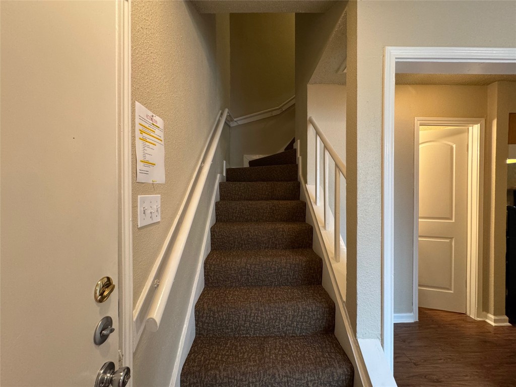 4904 West Wind Trail, Unit 102 Austin, TX 78745 - Photo 10 of 23 a view of staircase with wooden floor and white walls