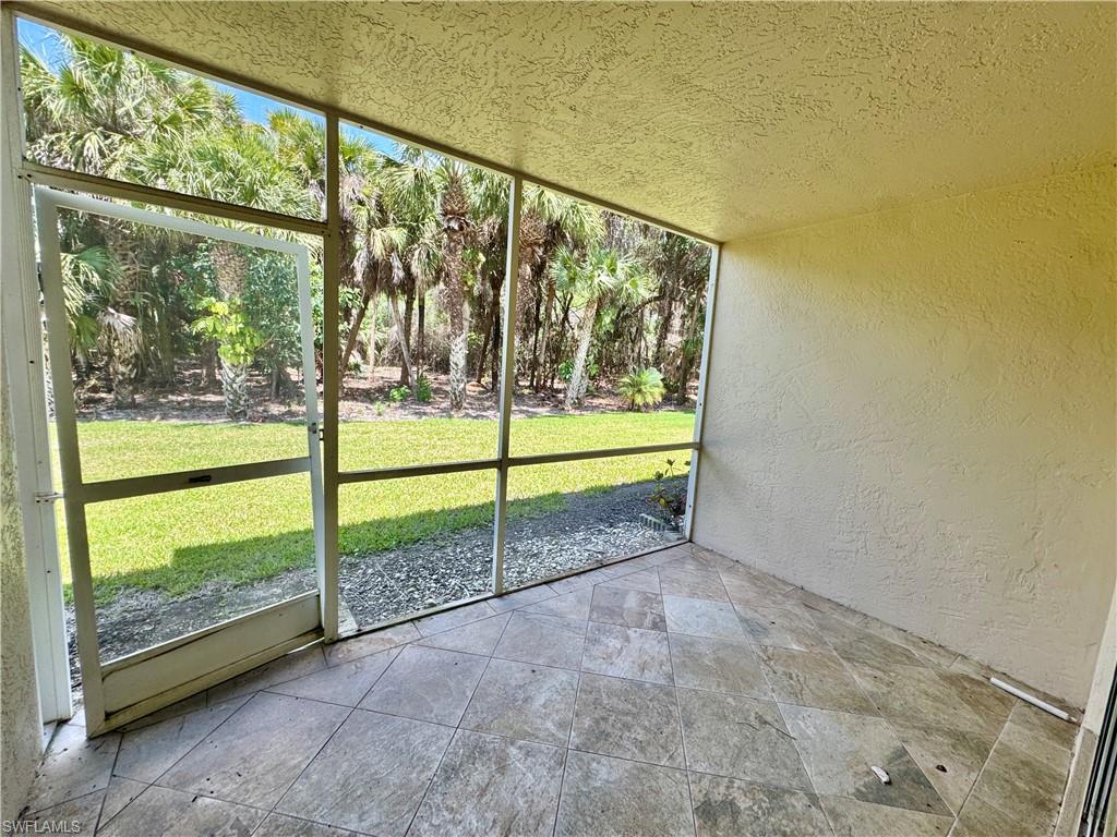 661 Squire Circle, Unit 101 Naples, FL 34104 - Photo 21 of 25 a view of a garden with small trees