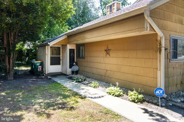 a backyard of a house with flower plants