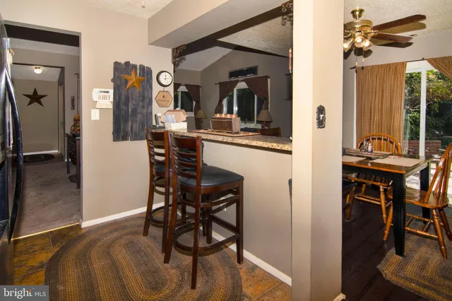 a view of a dining room with furniture and a chandelier