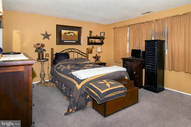 a bedroom with a bed and dresser