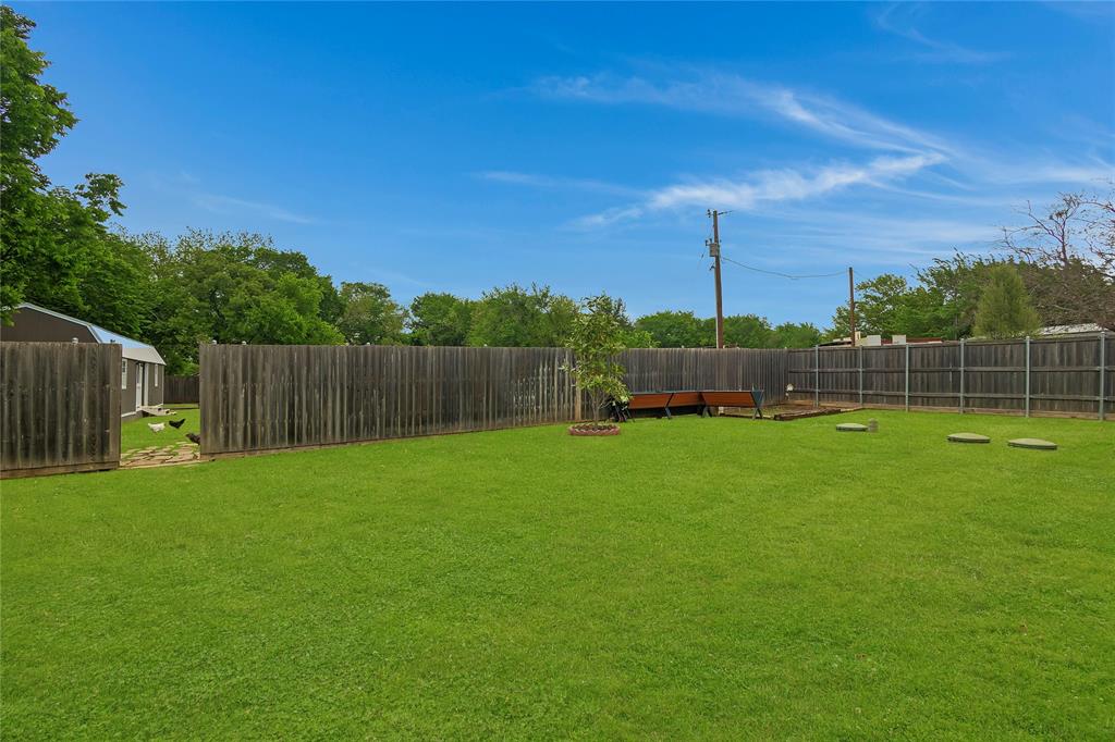 11061 Foutch Road Pilot Point, TX 76258 - Photo 33 of 37 Raised garden beds highlight productive outdoor space, while the entry to the back portion of the property provides easy access to additional usable land.
