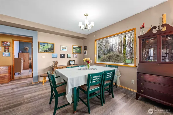 a view of a dining room with furniture window and wooden floor