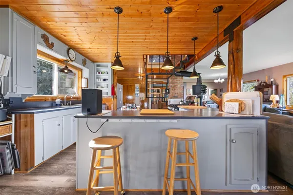 a kitchen with a sink appliances and cabinets