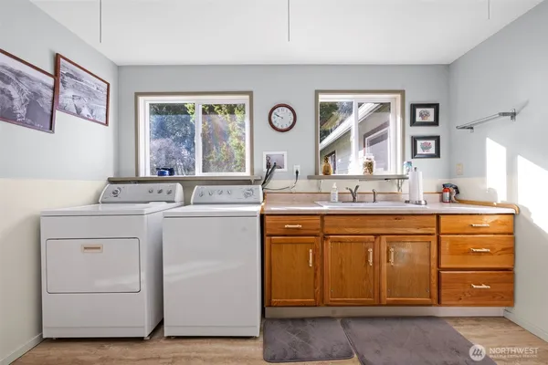 a bathroom with a granite countertop sink mirror and window