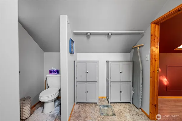 a bathroom with a toilet and a shower
