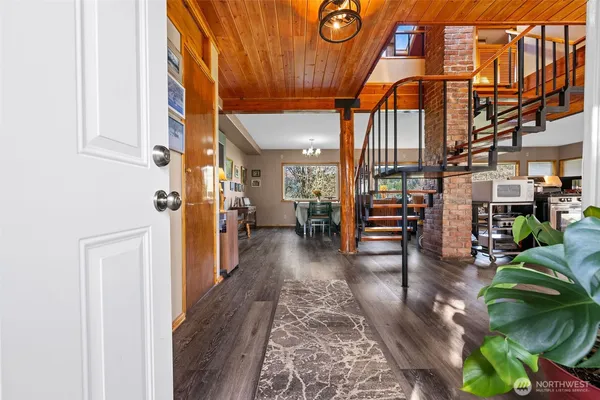 a view of entryway and hall with wooden floor
