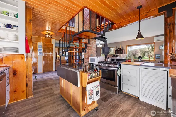 a kitchen view with stainless steel appliances granite countertop a stove and a refrigerator