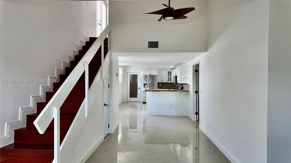 a view of entryway and kitchen