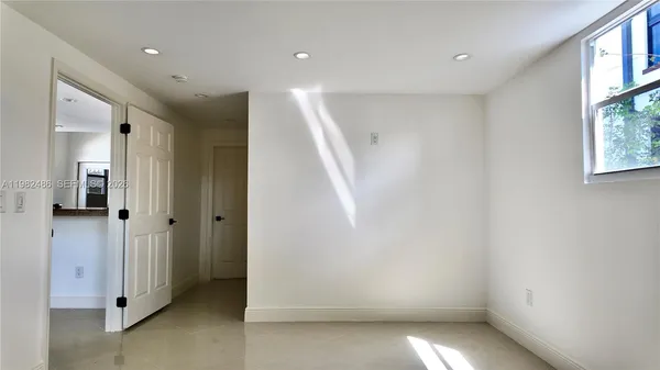 a view of hallway with window and stairs