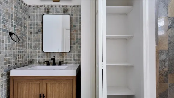 a bathroom with a sink and a mirror
