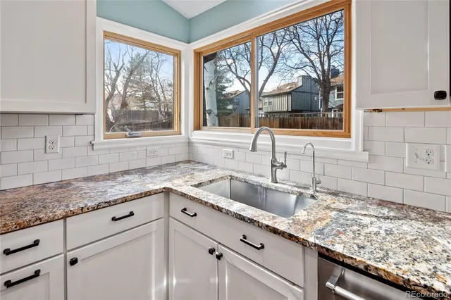 a kitchen with granite countertop a sink and a window