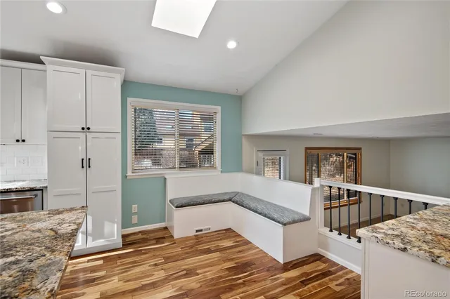 a living room with a bed next to a window