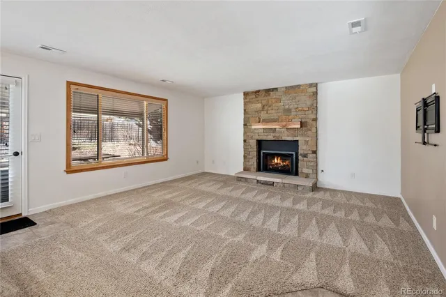 a view of empty room with fireplace