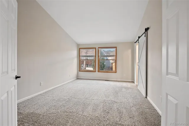 an empty room with windows and closet