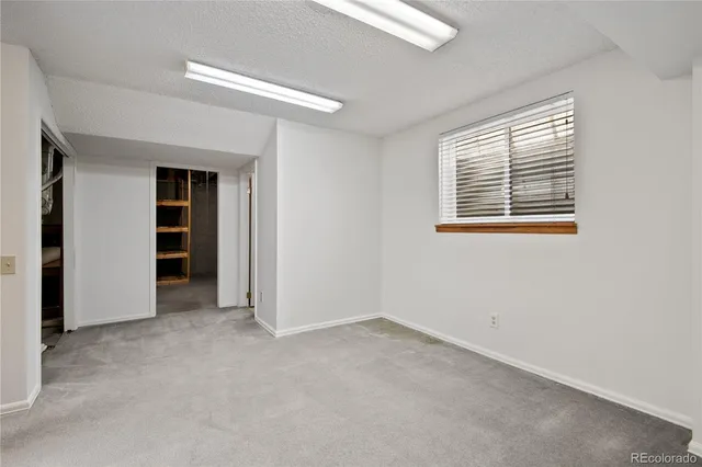 an empty room with closet area
