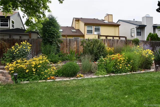 a front view of a house with a yard and fountain in middle