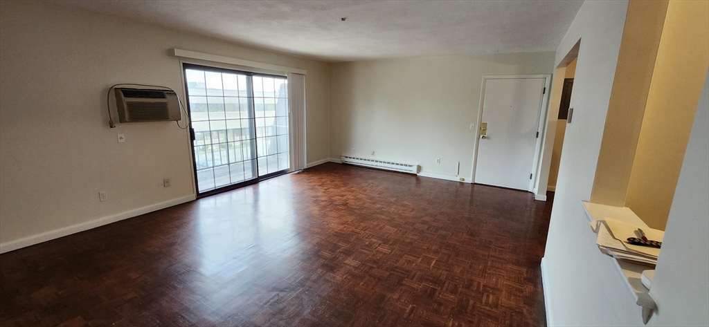 41 West Street, Unit C2 Randolph, MA 02368 - Photo 5 of 12 an empty room with wooden floor and windows