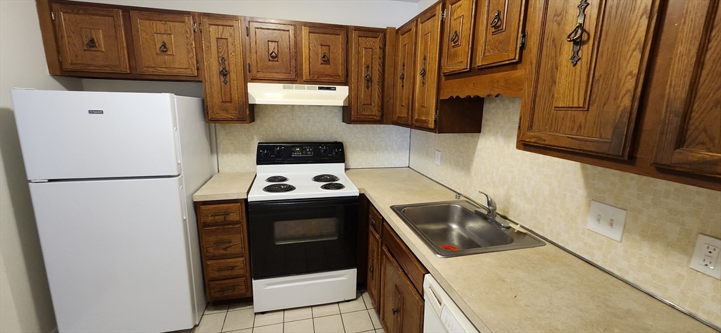 41 West Street, Unit C2 Randolph, MA 02368 - Photo 7 of 12 a kitchen with a refrigerator sink and cabinets