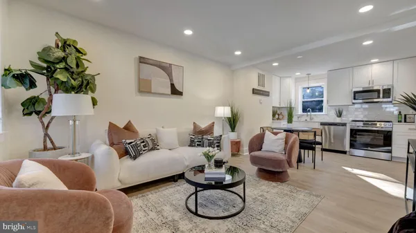 a living room with furniture a fireplace and a potted plant