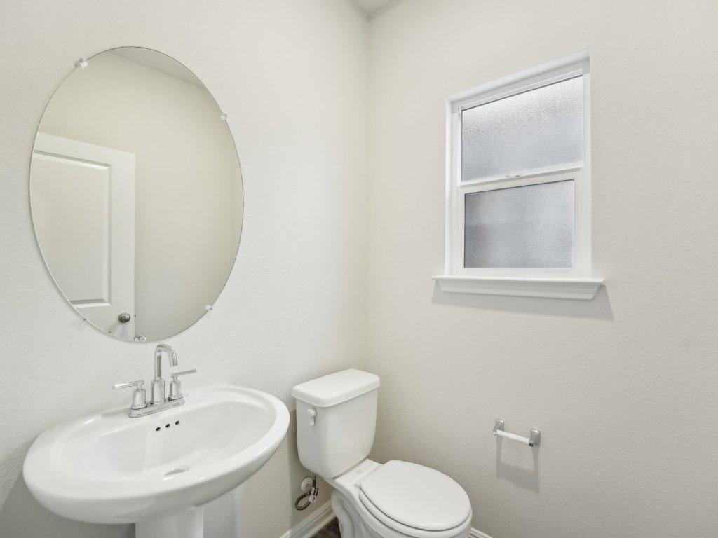 165 Calcite Road, Unit 1 Kyle, TX 78640 - Photo 5 of 15 a bathroom with a toilet sink and mirror