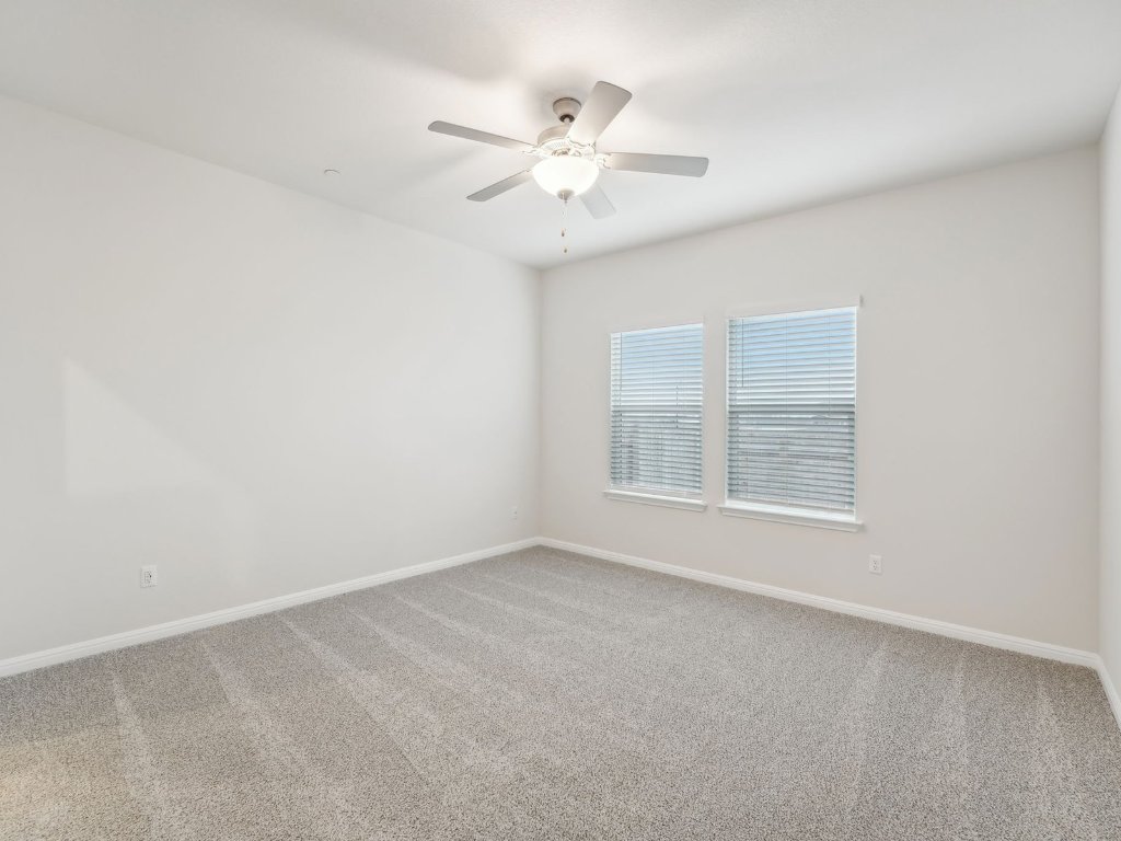 165 Calcite Road, Unit 1 Kyle, TX 78640 - Photo 7 of 15 an empty room with a window and a ceiling fan