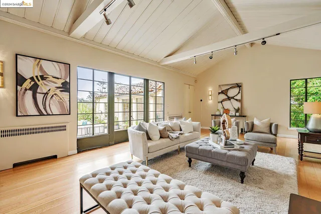 a living room with furniture a fireplace and a large window