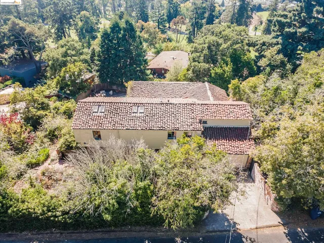 an aerial view of a house with a yard