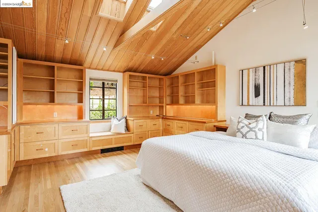 a bathroom with a tub a sink and a large mirror next to a window