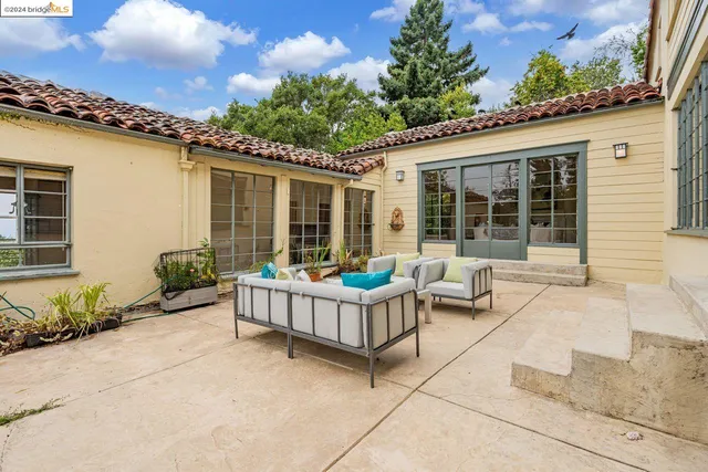an aerial view of a house with a yard and trees
