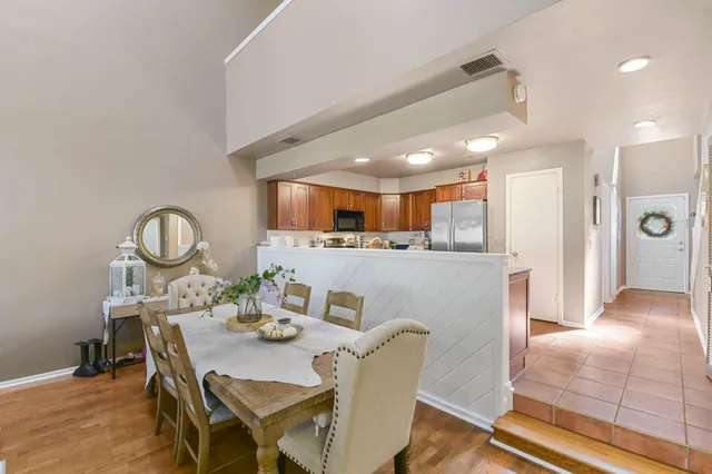 a view of a dining room with furniture and a chandelier