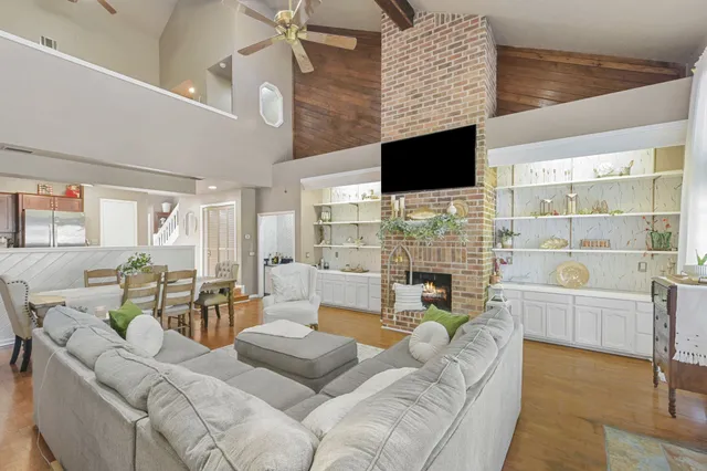 a living room with fireplace furniture and a flat screen tv
